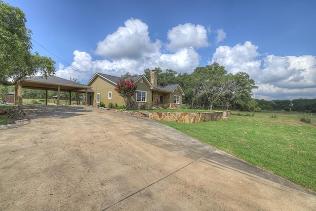 view of front of property with a front yard and a carport