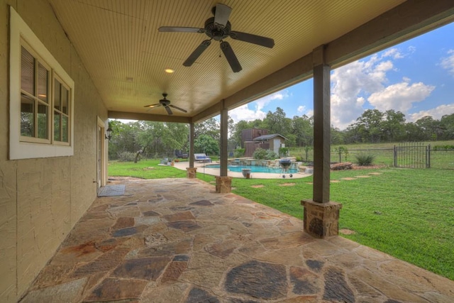 view of patio featuring ceiling fan and a fenced in pool