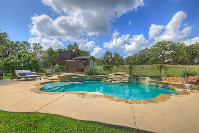 view of swimming pool with a patio area and an in ground hot tub