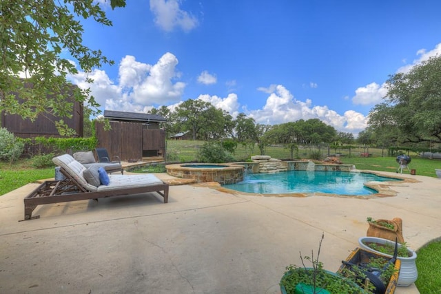 view of swimming pool featuring a patio area, an in ground hot tub, and pool water feature