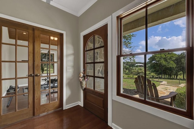 entryway with ornamental molding, dark wood-type flooring, and french doors