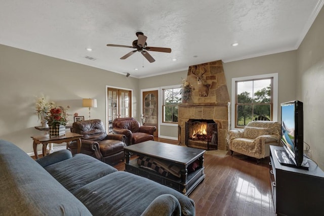 living room with ceiling fan, ornamental molding, dark wood-type flooring, and a wealth of natural light