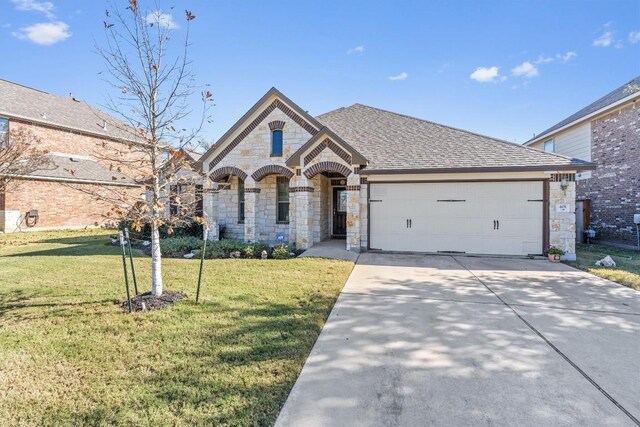 view of front of property with a garage and a front lawn