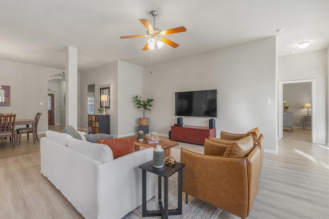 living room with ceiling fan and light hardwood / wood-style floors