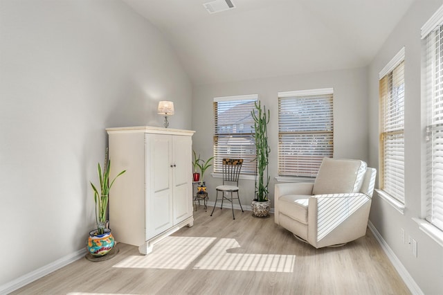 living area with light hardwood / wood-style flooring and lofted ceiling