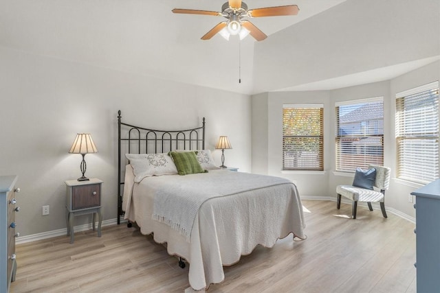 bedroom with ceiling fan, vaulted ceiling, and light hardwood / wood-style flooring