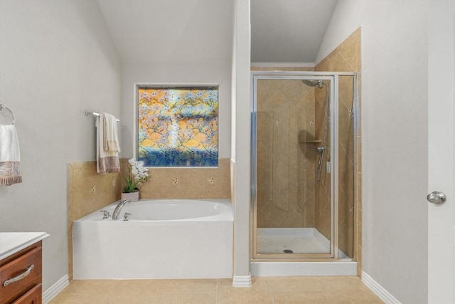 bathroom with tile patterned floors, plus walk in shower, and vaulted ceiling