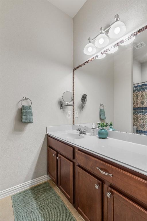 bathroom with tile patterned floors and vanity