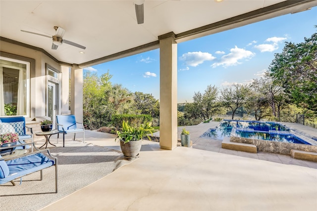 view of patio with ceiling fan and a pool with hot tub