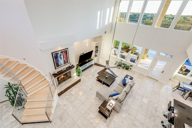 tiled living room with a towering ceiling and ceiling fan