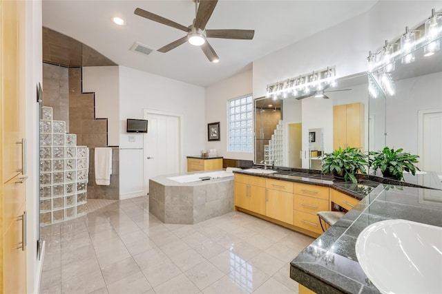 bathroom featuring ceiling fan, tile patterned flooring, plus walk in shower, and vanity