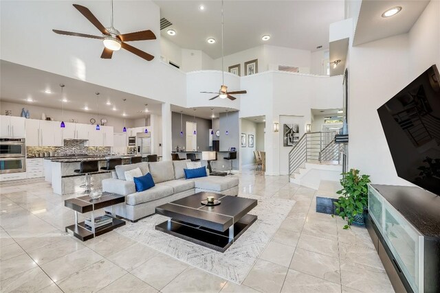 7302 Matisse Pointe Dr, Jonestown, TX 78645 - living room with ceiling fan, stairway, a high ceiling, and recessed lighting