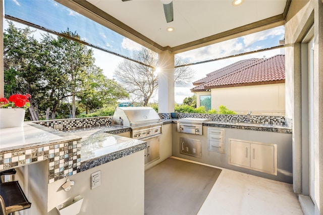 view of patio / terrace featuring sink, an outdoor kitchen, and grilling area