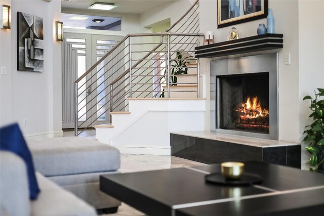 7302 Matisse Pointe Dr, Jonestown, TX 78645 - living area with stairway and a warm lit fireplace