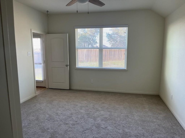 unfurnished room featuring ceiling fan, light colored carpet, and lofted ceiling