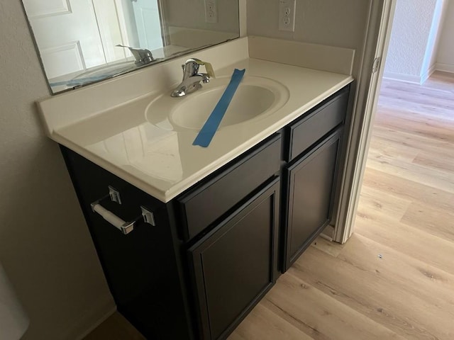 bathroom featuring wood-type flooring and vanity