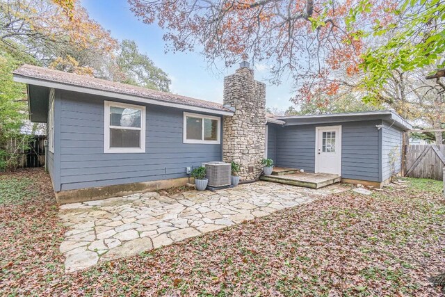 back of property with cooling unit and a patio