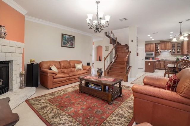 tiled living room with a fireplace, an inviting chandelier, and ornamental molding