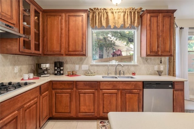 kitchen featuring a wealth of natural light, light tile patterned flooring, sink, and appliances with stainless steel finishes