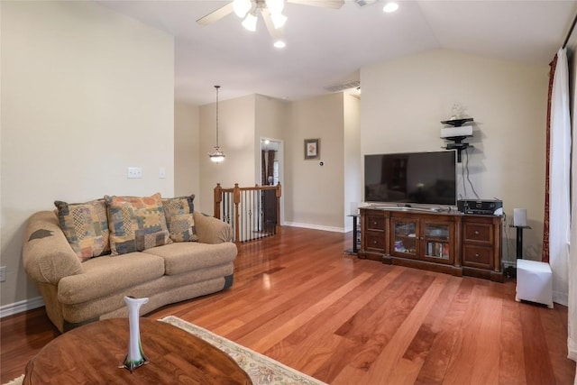 living room featuring ceiling fan, wood-type flooring, and lofted ceiling