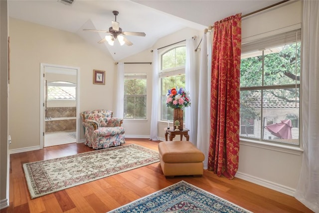 sitting room with hardwood / wood-style floors, ceiling fan, and lofted ceiling