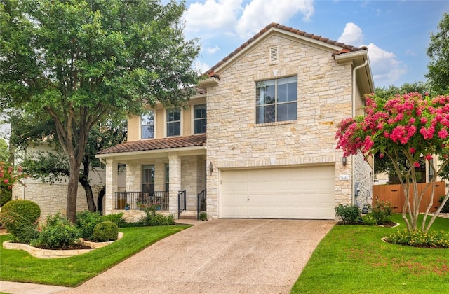 view of front of home with a front yard and a garage