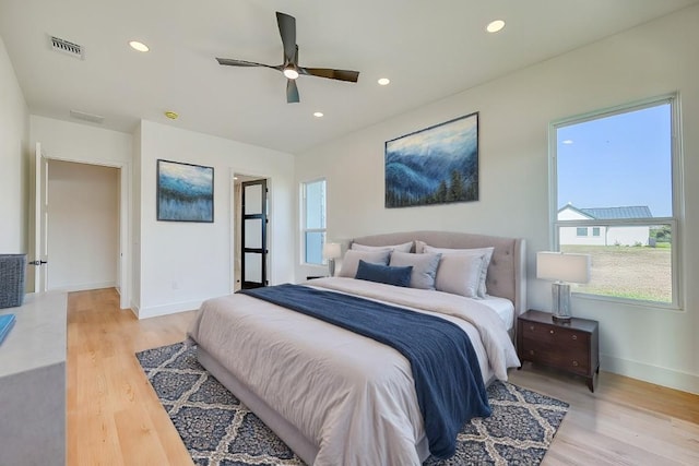 bedroom with ceiling fan and light hardwood / wood-style floors