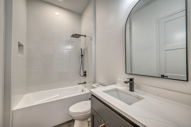 full bathroom featuring vanity, toilet, and tiled shower / bath