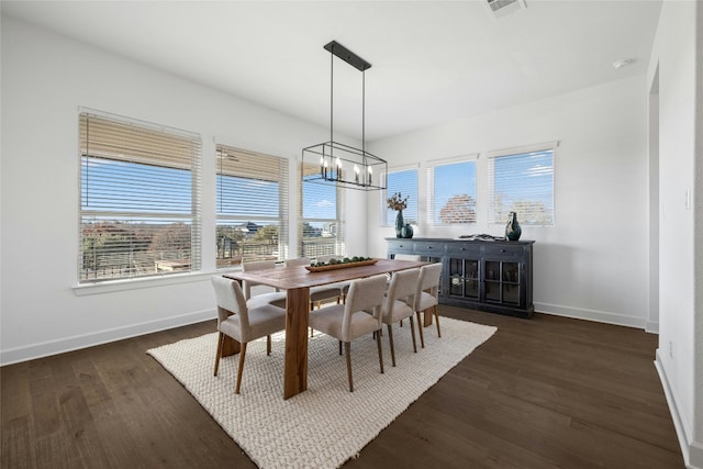 dining room featuring dark hardwood / wood-style flooring and a chandelier