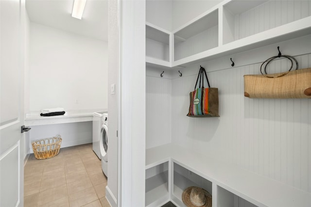 mudroom with light tile patterned flooring and separate washer and dryer