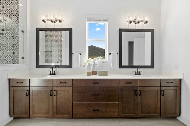 bathroom featuring tile patterned floors, a shower, and vanity