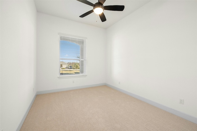 carpeted spare room with ceiling fan