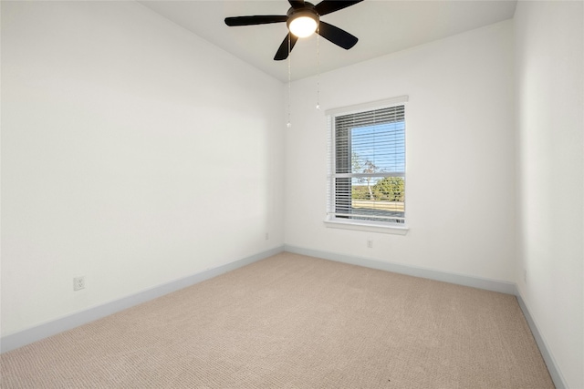 spare room with ceiling fan, carpet floors, and vaulted ceiling