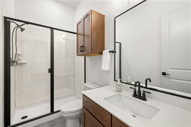 bathroom with vanity, toilet, and walk in shower