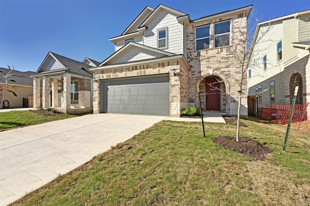 view of front of house featuring a garage and a front lawn