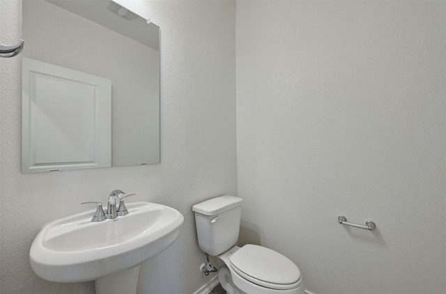 bathroom featuring toilet and sink