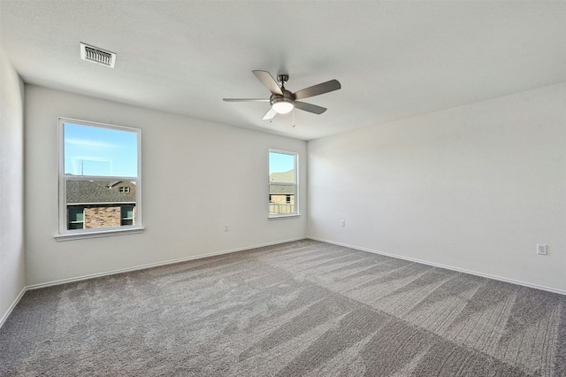 spare room featuring carpet and ceiling fan