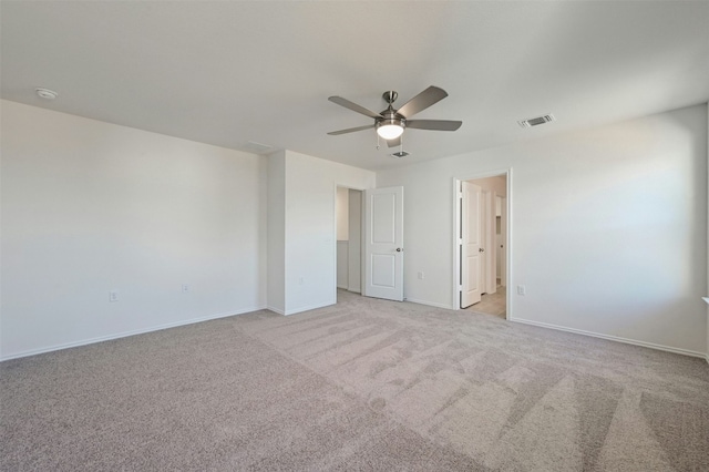 unfurnished room featuring ceiling fan and light colored carpet