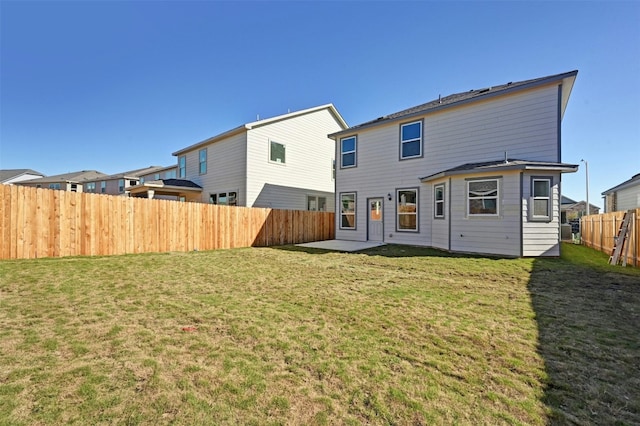 rear view of house featuring a yard