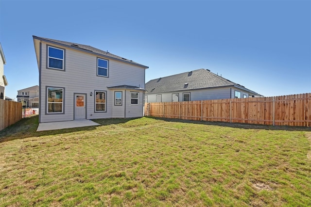 rear view of house with a patio and a lawn