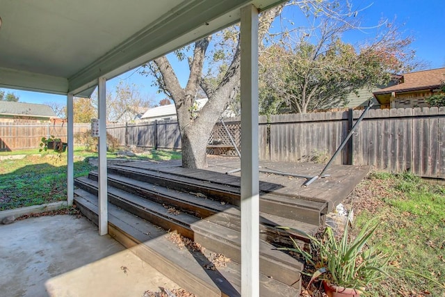 wooden terrace with a patio area