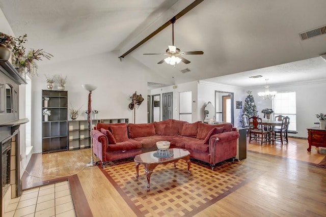 living room featuring vaulted ceiling with beams, crown molding, ceiling fan with notable chandelier, and light wood-type flooring