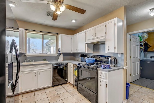 kitchen featuring black appliances, light tile patterned flooring, white cabinetry, and sink