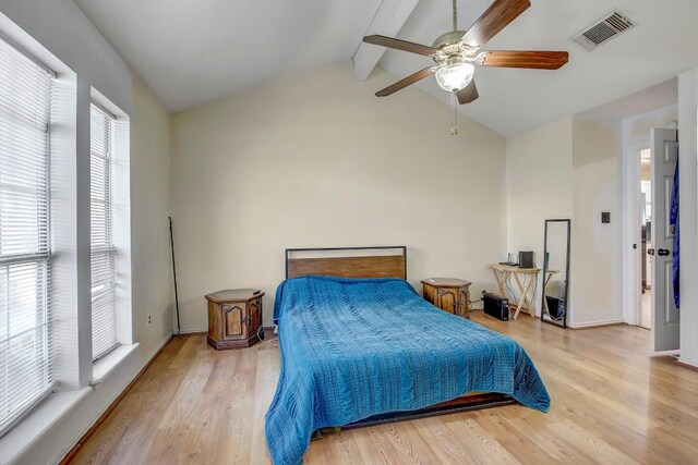 bedroom featuring vaulted ceiling with beams, light hardwood / wood-style flooring, and ceiling fan