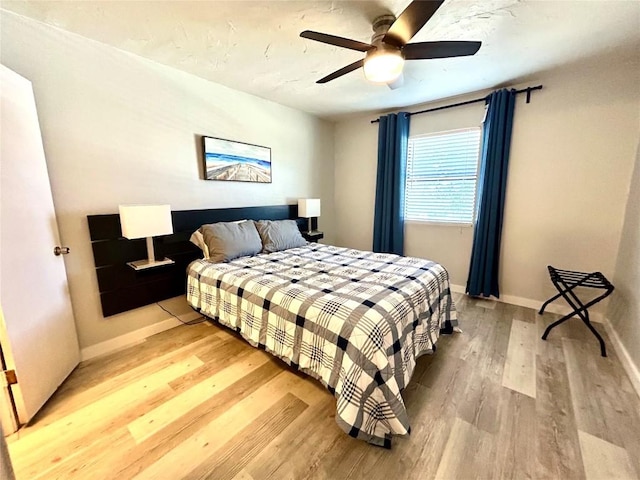 bedroom featuring ceiling fan and light hardwood / wood-style flooring