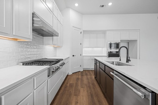 208 San Xavier St, Georgetown, TX 78633 - kitchen with stainless steel appliances, extractor fan, light countertops, white cabinets, and recessed lighting