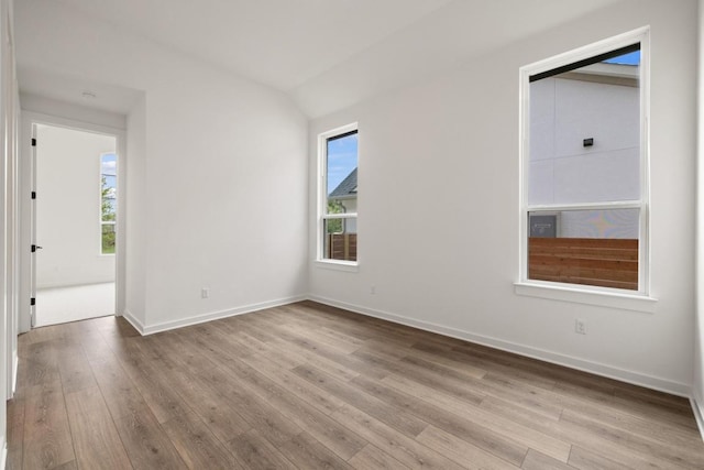 208 San Xavier St, Georgetown, TX 78633 - spare room featuring plenty of natural light, wood finished floors, and lofted ceiling