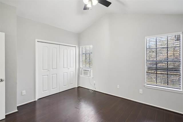 unfurnished bedroom featuring lofted ceiling, a closet, ceiling fan, and dark wood-type flooring