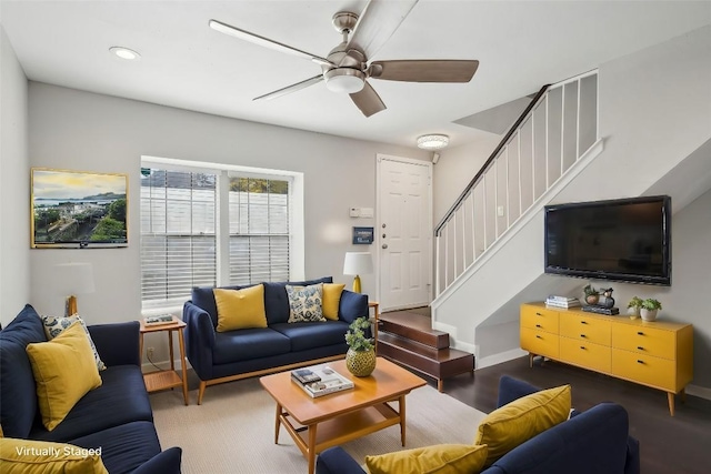 living room featuring ceiling fan and dark hardwood / wood-style floors