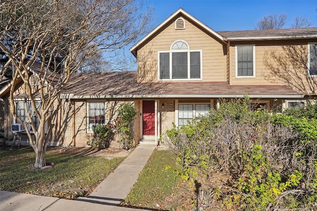 view of property with cooling unit and a front yard